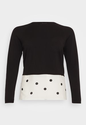 Îmbrăcăminte neagră cu mâneci lungi, având un design scurt, cu un panou inferior alb decorat cu buline negre. Textură netedă pe toată suprafața.