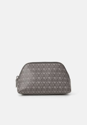 Gray textured cosmetic pouch with a repeating pattern, zip closure, and silver hardware. Contoured shape for easy storage.