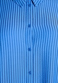 Niebieska koszula z guzikami, w pionowe ciemnoniebieskie i jasnoniebieskie paski, z widocznymi czterema guzikami i klasycznym kołnierzykiem.