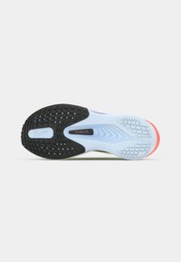 Nike running shoe outsole with a mix of black and light blue rubber. Features textured grip, angular patterns, a soft pink heel, and a label.