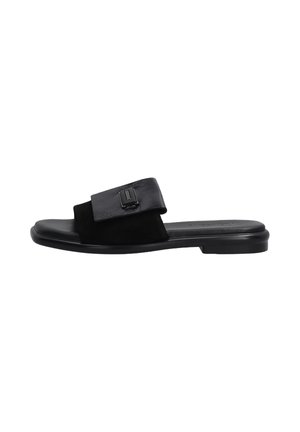 Black slide sandal featuring a mix of smooth and textured leather, wide strap with a metallic accent and a low, flexible sole.