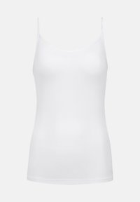 Camisole blanche ajustée avec des fines bretelles, décolleté rond et design sans coutures sur un fond gris clair uni.