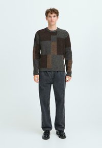 Strickpullover mit einem Patchwork-Design in dunkelgrauen, braunen und beigen Farbtönen; strukturiertes Gewebe; runder Halsausschnitt; gerippte Bündchen und Saum.