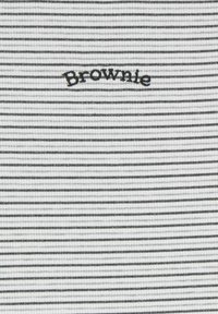 Black and white striped fabric with a ribbed texture; features the embroidered word "Brownie" in black above the central stripe.