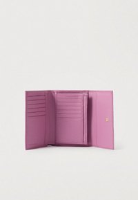 Tri-fold pink leather wallet opened, showing multiple card slots and a snap button closure on a plain white background.