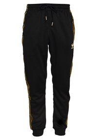 Svarta mjukisbyxor i mjukt tyg, med gula ränder längs sidorna och ett elastiskt midjeband med dragsko. Gyllene logotypdetalj.
