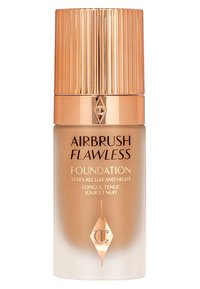Airbrush Flawless Foundation in a transparent tan bottle with a striped gold cap. Features black text on a white gradient background, detailing use.