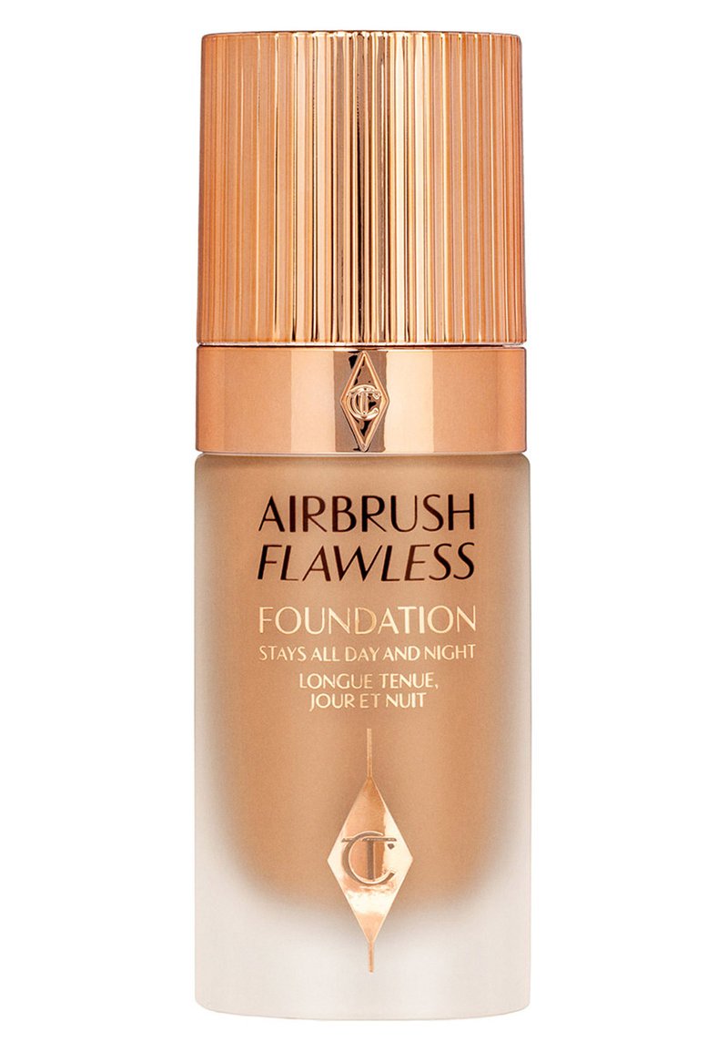 Airbrush Flawless Foundation in a transparent tan bottle with a striped gold cap. Features black text on a white gradient background, detailing use.