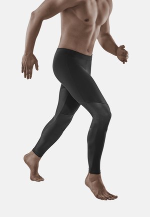 Schwarze sportliche Leggings mit einer figurbetonten Passform, ausgestattet mit strukturierten Einsätzen und einem glatten Bündchen. Geeignet für Sportbekleidung und Bewegungsfreiheit.