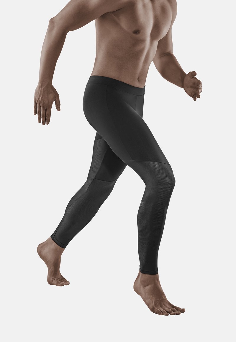 Leggings atletiche nere con un design aderente, caratterizzati da pannelli testurizzati e una vita liscia. Adatti per l'abbigliamento sportivo e per il movimento.
