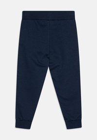 Navy blue cotton joggers with an elastic waistband and ribbed cuffs. Smooth texture, straight leg design, and no visible patterns or accents.
