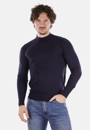 Maglione a collo alto lungo blu navy con design aderente. Tessuto liscio con polsini e vita a costine, realizzato in tessuto morbido.
