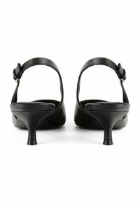 Black leather heeled sandals with a rounded toe, narrow ankle strap, and a slender mid-height heel. Smooth texture and minimal design details.
