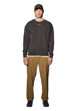 Grau gestreifter Pullover mit gesticktem "HALO", helle Hose und schwarze Sneakers. Das Outfit ist lässig und hat ein einfaches, entspanntes Design.