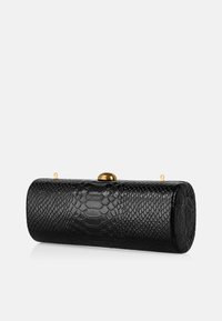 Black, textured clutch with a snake pattern, cylindrical shape, gold clasp, and two small loops for straps. Smooth surface with raised scales.