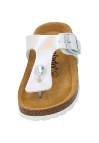 White sandal with shiny upper, adjustable silver buckle, soft brown suede footbed, and cork sole with a white rubber bottom.