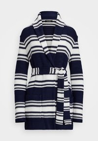Navy och vit randig kofta med sjalkrag och knytband i midjan, samt två framfickor; texturerat stickat tyg med varierande randbredd.