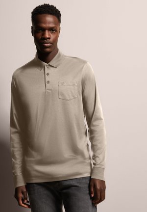 Beige long-sleeved polo shirt with three buttons and a left chest pocket, made of a smooth material with a subtle sheen.