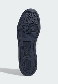 Suela de zapato de goma azul marino, con patrones de textura en la banda de rodadura y un acento circular prominente, diseñada para proporcionar agarre y estabilidad.