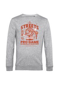 Felpa grigia con colletto a girocollo caratterizzata da un design grafico arancione con un personaggio di cartone che gioca a basket e la scritta: "STREETS PRO GAME DUNKING DOWNTOWN."