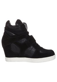 Musta kiilakorkonilkkurit, jotka on valmistettu teksturoidusta mokkanahasta ja sileästä nahasta. Niissä on korkeavartinen malli, rei’itetyt paneelit ja säädettävä hihna.