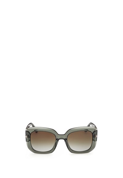 Lunettes de soleil carrées surdimensionnées avec des montures translucides vert foncé et des verres bruns dégradés, avec un détail métallique sur les branches.