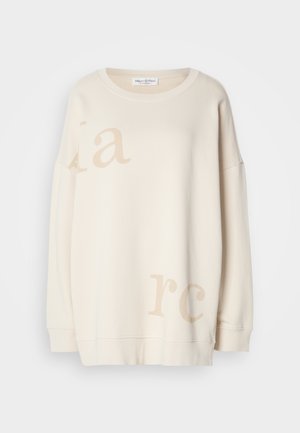 Crème kleurige sweatshirt gemaakt van zachte stof, met een relaxte pasvorm, verlaagde schouders en lichtbeige bedrukte letters.