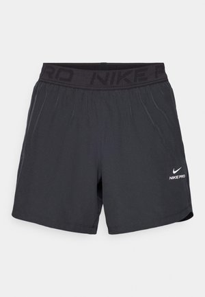 Short de sport Nike Pro noir avec taille élastique et petit logo Nike blanc sur la partie inférieure de la jambe droite.