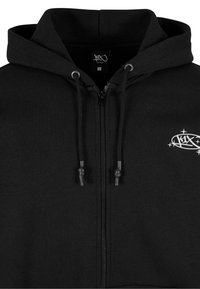Haut à zip noir avec poches avant, cordons de serrage ajustables et un petit logo blanc sur le côté gauche. Fabriqué en coton doux.