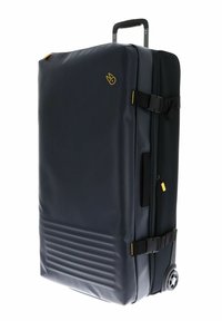 Valise noire à roulettes fabriquée en matériau lisse et durable avec une finition mate, dotée d'une poignée télescopique, d'une fermeture éclair et de sangles réglables.