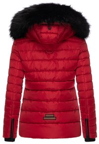 Red padded jacket with a detachable black faux fur hood. Features quilted texture, side zippers, and a leather logo patch on the hem.