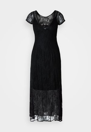 Svart blondekjole med korte cap sleeves, som har en tettsittende liv og en flytende skjørt. Blonden har blomsterdesign og et gjennomsiktig lag.