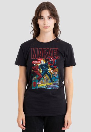 Young woman wearing a black Marvel T-shirt featuring Spider-Man, Ghost Rider, and comic-style action scenes with "Tombstone" text.