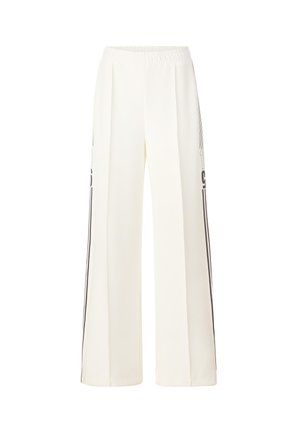 Pantaloni a gamba larga in tessuto crema con elastico in vita. Presentano righe laterali nere e cuciture pulite per un aspetto lineare.