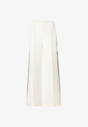 Wide-leg trousers in cream fabric with an elastic waistband. Features black side stripes and clean stitching for a streamlined look.