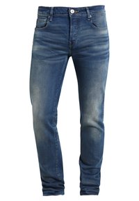 Siniset slim-fit-farkut denimmateriaalia, joissa on haalistettu pesu, keskitason vyötärö, etutaskut ja tavallinen vetoketjukiinnitys.