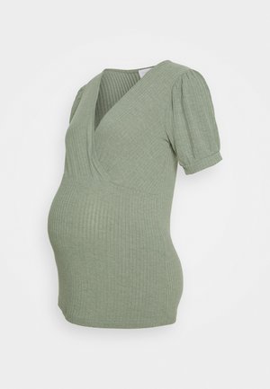 Maternity top in light green ribbed fabric, features a v-neckline and short puff sleeves, designed for a comfortable fit during pregnancy.