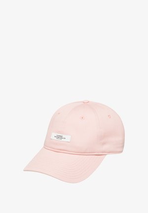 Pink cotton baseball cap with a curved brim, featuring a white logo patch on the front and ventilation eyelets on the crown.