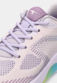 Ελαφρύ παπούτσι τρεξίματος με ανώτερο από δίχτυ σε λιλά, υφασμάτινες λεπτομέρειες και μια κλίμακα σόλας που μεταβαίνει από μπλε σε πράσινο.