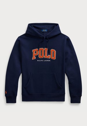 Tumši zilas kapuci krekls ar priekšējo kabatu, kas rotāta ar oranžu izšūtu "POLO" logotipu un tekstu "RALPH LAUREN" zem tā. Iekļautas saites.