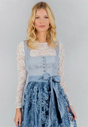 Traditional dress featuring a light blue embroidered bodice, silver buttons, and a flowing blue lace skirt with a satin bow at the waist.