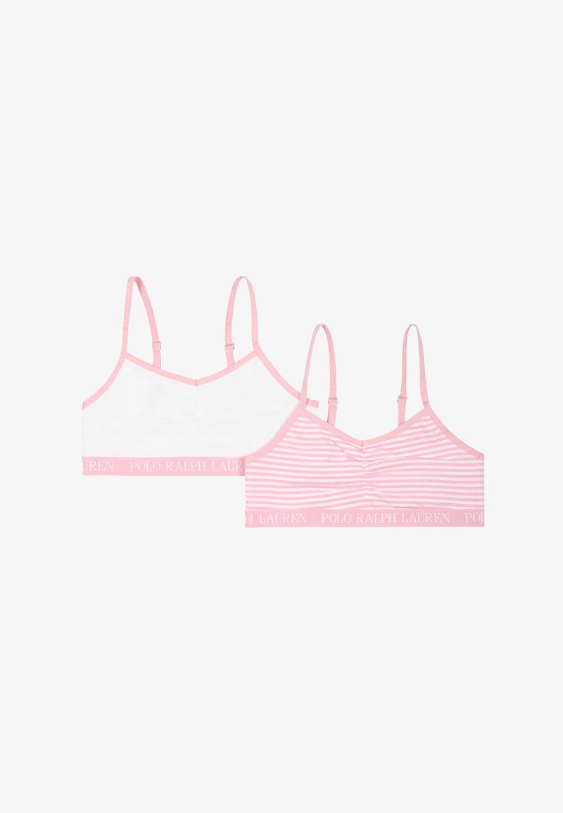 Deux bralettes sportives rose et blanche avec des bretelles ajustables, l'une entièrement blanche et l'autre à rayures roses, toutes deux avec des bandes portant le logo Polo Ralph Lauren.