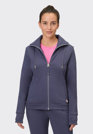 Navy zip-up hoodie made of soft fabric. Features a high collar, adjustable drawstrings, and front pockets. Smooth texture, fitted design.