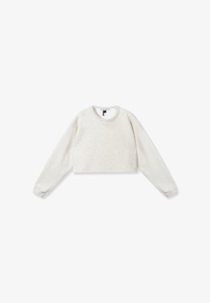 Felpa cropped in tessuto beige chiaro, con maniche lunghe, scollatura tonda e polsini a costine. Sottile texture su tutta la superficie.