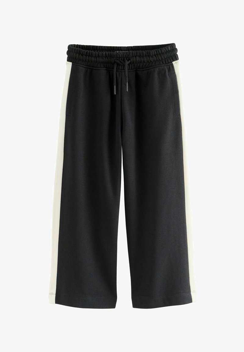 Un pantalon de survêtement noir avec un accent latéral blanc, doté d'une taille élastique et d'un cordon de serrage. Fabriqué en tissu doux et extensible.
