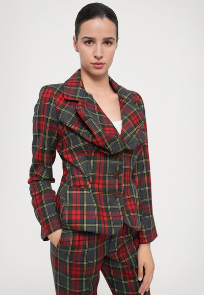 Red, green, and gray plaid fitted blazer with large lapels, three brown buttons, and long sleeves. Matching plaid trousers are also visible.