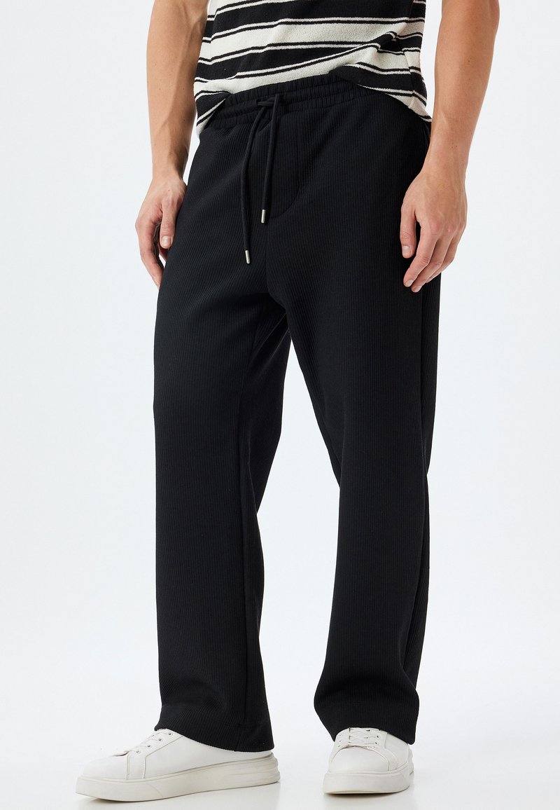 Tracksuit Drawstring Koton DRAWSTRING - Tracksuit bottoms - black - Zalando