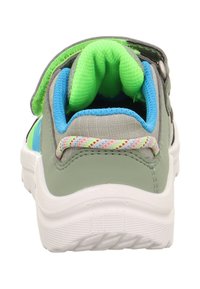 Kindersportschuh mit grauem und grünem Obermaterial, blauen Akzenten, gepolstertem Schuhkragen, verstellbarem Riemen und strukturiertem weißen Sohlen.