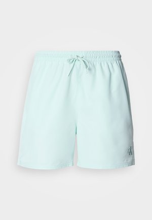 Svetlo mätovo zelené plavecké šortky s elastickým pásom, šnúrkovým zapínaním a malým logom v dolnej ľavej časti.