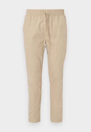 Pantaloni bej, ușori, cu talie elastică și șnur. Design cu picioare drepte, textură netedă și fără modele sau accente vizibile.